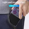 A hand is holding a purple handheld game console and placing it into a denim jeans pocket. Produktbild-Vorschau