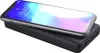 A smartphone is placed on top of a black power bank. Produktbild-Vorschau