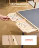 A person's hand is shown pulling out a drawer from a puzzle board, revealing puzzle pieces sorted within. Produktbild-Vorschau
