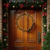 A decorated wooden door with a Christmas wreath and garland. Anteprima dell’immagine prodotto