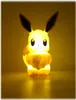 A lit-up Eevee figurine is shown against a yellow background. Náhľad obrázku produktu