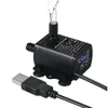A black USB water pump with water flowing out of it, shown on a white background. Náhľad obrázku produktu