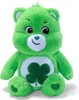 A green stuffed bear with a shamrock on its chest sits against a white background. Produktbild-Vorschau