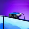 A webcam is mounted on top of two computer monitors, with a purple background. Produktbild-Vorschau