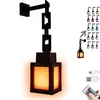A pixel-style lantern lamp with a chain, mounted on a wall bracket, emitting an orange glow. Several smaller images show color options, USB cables, and a remote control. Produktbild-Vorschau