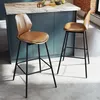 Two brown bar stools with black legs are placed in front of a kitchen island with a marble countertop. Podgląd zdjęcia produktu