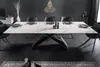 A modern dining room with a large marble-effect extendable dining table and black chairs. Produktbild-Vorschau