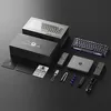 A collection of gaming keyboard accessories and packaging laid out on a dark surface. Produktbild-Vorschau