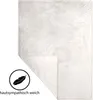A white blanket folded in half, with a corner lifted to show the underside. A circular icon with a feather and text is in the bottom left corner. Produktbild-Vorschau