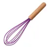 A kitchen whisk with a wooden handle and purple silicone wires is shown against a white background. Produktbild-Vorschau