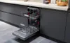 A dishwasher with its door open, showing the racks inside, in a modern kitchen setting. Produktbild-Vorschau