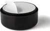 A black furniture foot with a white sticker being peeled off. Produktbild-Vorschau