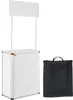 A white promotional counter with a banner on top and a black carrying bag next to it, all on a white background. Náhľad obrázku produktu