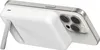 A white Belkin BoostCharge Pro magnetic power bank is attached to the back of a silver iPhone, with the power bank's kickstand extended. Voir les images du produit