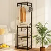 A coat rack with shelves in a living room next to a sofa and a plant. Náhled obrázku produktu