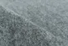 A close-up, angled view of a grey carpet tile. Produktbild-Vorschau