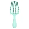 A mint green detangling brush with black bristles is shown against a white background. Podgląd zdjęcia produktu