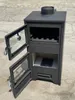 A black wood-burning stove with its doors open, placed outdoors on a paved surface. Produktbild-Vorschau