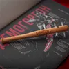 A close-up of a spiked baseball bat pen with the "Stranger Things" logo, resting on an open book with anatomical diagrams and text. Produktbild-Vorschau