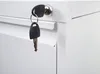 A close-up view of a white filing cabinet with two keys hanging from the lock. Anteprima dell’immagine prodotto