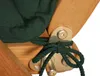 A close-up view of a dark green cushion tied to a wooden chair with a metal bracket. Produktbild-Vorschau