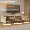 A TV stand with multiple storage compartments, drawers, and a cabinet, shown in a living room setting with a TV mounted on the wall above it. Produktbild-Vorschau
