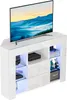 A modern, white, high-gloss TV stand with integrated LED lighting, displaying a television and various decorative items. Voir les images du produit