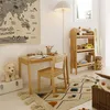 A child's room with a wooden desk, chair, bookshelf, and rug. Náhled obrázku produktu