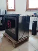 A fireplace insert is placed on a wooden pallet in a room with tiled flooring and windows in the background. Náhled obrázku produktu