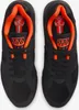 A top-down view of a pair of black Nike Air Max 180 sneakers with orange accents. Náhľad obrázku produktu