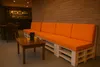 A modern lounge area with a pallet sofa and a small coffee table. Produktbild-Vorschau