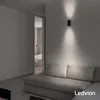 A modern living room with a sofa and a doorway leading to a bedroom. Produktbild-Vorschau