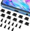 A set of black cleaning tools and plugs for phone ports, laid out on a white background, with a close-up of a blue smartphone in the background. Voir les images du produit