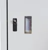 A close-up view of a lock and a handle on a light gray surface, likely a cabinet or locker. Náhled obrázku produktu