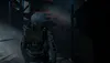 A person in a futuristic suit walks through a dimly lit, industrial-looking corridor. Náhľad obrázku produktu