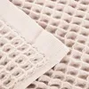 A close-up view of a beige waffle-weave towel. Produktbild-Vorschau