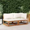 An outdoor sofa set with cream cushions is placed on a tiled patio in front of a lush green hedge. Náhled obrázku produktu