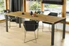 A dining table and chairs set in a modern dining room with large windows overlooking a garden. Podgląd zdjęcia produktu