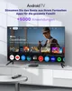 A modern living room setup with a large TV displaying an Android TV interface, a streaming box, and a remote control on a table. Voir les images du produit