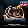 A gloved hand is applying orange grease to a ball bearing. Produktbild-Vorschau