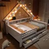 A child's bed with a house-shaped frame and LED lights, decorated with pillows and a teddy bear. Produktbild-Vorschau