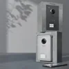 Two intercom systems are displayed, one stacked on top of the other, against a light gray wall with shadows. Produktbild-Vorschau