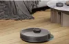 A robot vacuum cleaner is cleaning a wooden floor next to a sofa and a coffee table. Náhľad obrázku produktu