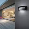 A modern bedroom with a large sliding glass door opening to a wooden deck, and a black wall lamp mounted on the exterior wall. Anteprima dell’immagine prodotto