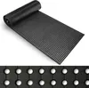 A black rubber mat with a pattern of white dots, partially unrolled on a white background. Podgląd zdjęcia produktu