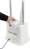 A hand is shown interacting with a white garment steamer, specifically lifting or opening a compartment. Náhled obrázku produktu