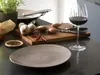 A kitchen counter with ingredients and a plate, ready for cooking. Produktbild-Vorschau