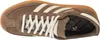 A top-down view of a brown Adidas sneaker with cream laces and stripes. Voir les images du produit