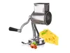A stainless steel rotary grater with a black handle sits next to a wedge of Swiss cheese and hazelnuts on a white background. Náhľad obrázku produktu