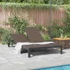 A double sun lounger is placed on a patio next to a swimming pool, with a wooden fence and greenery in the background. Anteprima dell’immagine prodotto